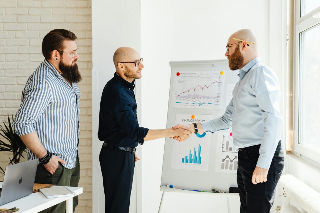 Three business colleagues engage in a productive meeting, exchanging ideas with data charts.